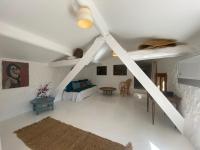 a living room with a ceiling fan and a table at Campagne Salettes in Lorgues