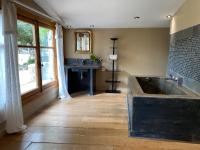 a bathroom with a large tub and a fireplace at Campagne Salettes in Lorgues
