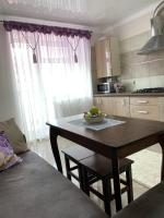 a kitchen with a table with a bowl of fruit on it at Центр. Поруч Парк та Став (3) in Ternopilʼ