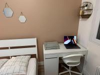 a bedroom with a desk with a laptop on it at Appartement Prestige - Amiens in Amiens