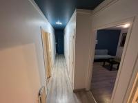 a hallway with blue ceilings and a room with a bed at Appartement Prestige - Amiens in Amiens