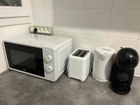 a microwave sitting on a counter next to a trash can at Appartement Prestige - Amiens in Amiens