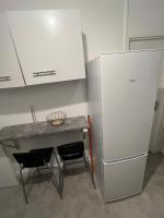 a kitchen with a table and a refrigerator at Appartement Prestige - Amiens in Amiens