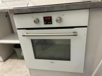 a white oven with a clock on it in a kitchen at Appartement Prestige - Amiens in Amiens