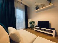 Televízia a/alebo spoločenská miestnosť v ubytovaní Wileńska home apartment 3