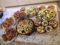 a table topped with lots of different types of pizzas at Gîte les Granges dans ferme provençale. 14 pers in Ongles