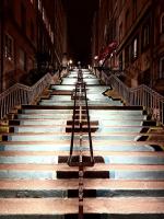 a set of stairs in a city at night at Le soyeux in Lyon
