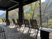 a row of chairs and tables on a patio with a view at Tangyue Resort in Tai&#39;an