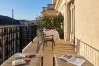 a balcony with a table and chairs on a building at Hôtel Raphael in Paris