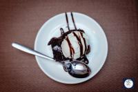 a piece of chocolate cake on a plate with a spoon at Himalayan Glory Inn in Pokhara