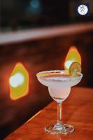 a martini glass with a lime on a table at Himalayan Glory Inn in Pokhara
