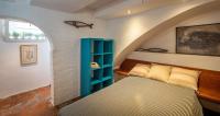 A bed or beds in a room at Flateli Sa Tuna Apartment