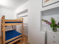A bed or beds in a room at Flateli Sa Tuna Apartment