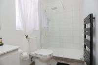 a white bathroom with a toilet and a shower at Hostellerie LE PANEL in Mandelieu-La Napoule