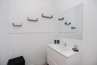 a white bathroom with a sink and a mirror at Hostellerie LE PANEL in Mandelieu-La Napoule