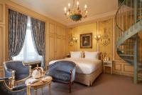 a bedroom with a bed and a staircase and a stair case at Hôtel Raphael in Paris