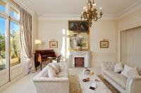 a living room with two couches and a piano at Hôtel Raphael in Paris