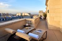a balcony with chairs and tables on a building at Hôtel Raphael in Paris