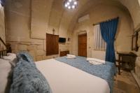 A bed or beds in a room at Emit Cave Hotel