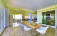 a dining room with a wooden table and white chairs at Amazing Home In Kastel Stari With Kitchen in Kastel Novi