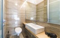 a bathroom with a sink and a toilet and a mirror at Amazing Home In Kastel Stari With Kitchen in Kastel Novi