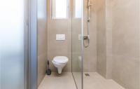 a bathroom with a toilet and a glass shower at Amazing Home In Kastel Stari With Kitchen in Kastel Novi