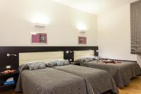A bed or beds in a room at Domus Best Guest House