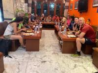 eine Gruppe von Menschen, die an Tischen in einem Restaurant sitzen in der Unterkunft Hotel Pomelo House in Kathmandu