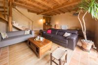 a living room with a couch and a table at MAISON YUKTI - Magnifique maison de charme proche plage in Lampaul-Ploudalmézeau