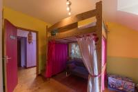 a bedroom with a bunk bed with pink curtains at MAISON YUKTI - Magnifique maison de charme proche plage in Lampaul-Ploudalmézeau