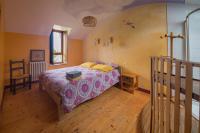 a bedroom with a bed and a wooden floor at MAISON YUKTI - Magnifique maison de charme proche plage in Lampaul-Ploudalmézeau