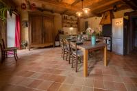 a kitchen with a table and chairs and a refrigerator at MAISON YUKTI - Magnifique maison de charme proche plage in Lampaul-Ploudalmézeau