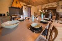 a kitchen with a large wooden table with a bowl on it at MAISON YUKTI - Magnifique maison de charme proche plage in Lampaul-Ploudalmézeau