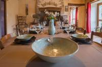 a dining room table with a bowl on top of it at MAISON YUKTI - Magnifique maison de charme proche plage in Lampaul-Ploudalmézeau