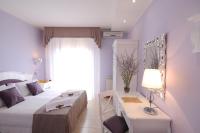 a bedroom with a bed and a table with a lamp at Hotel I Due Cigni in Montepulciano