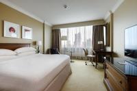 a hotel room with a bed and a desk and a television at Warsaw Presidential Hotel in Warsaw