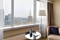 a hotel room with a table and a window at Warsaw Presidential Hotel in Warsaw
