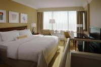 a hotel room with a large bed and a television at Warsaw Presidential Hotel in Warsaw