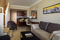 a living room with a couch and a dining room at Warsaw Presidential Hotel in Warsaw