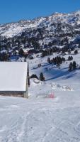 a snow covered mountain with a barn in the foreground at GITE LES 3 EDELWEISS - Maison SEGUITTE - 6 PERSONNES in Arette