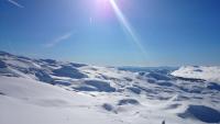 a snow covered mountain with the sun in the sky at GITE LES 3 EDELWEISS - Maison SEGUITTE - 6 PERSONNES in Arette