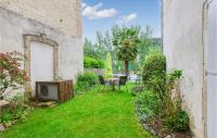 a garden with a table and chairs and a tv at Cozy Apartment In Saint Jean Du Bruel With Private Swimming Pool, Can Be Inside Or Outside in Saint-Jean-du-Bruel