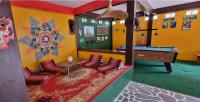 a room with a pool table and couches at Wild Hippie Chang in Ban Nong Si Chaeng