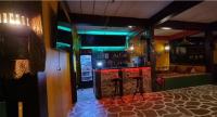 a bar with red and green lights in a room at Wild Hippie Chang in Ban Nong Si Chaeng