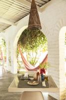 a dining room with a table and a hanging basket at Casa na Lagoa in Paracuru