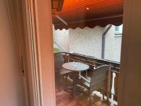 a balcony with a table and chairs and a window at Hotel Specht in Witten