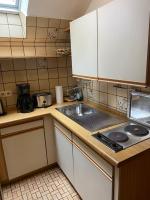 a kitchen with a sink and a counter top at Hotel Specht in Witten