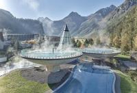 two hot springs in a resort with mountains in the background at Hotel Garni Löwen in Silz