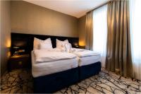 Łóżko lub łóżka w pokoju w obiekcie Hotel Szatmári & Étterem Jászberény