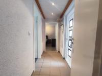 a hallway of a house with white walls and a door at Gästehaus im Alten Fährhaus in Cochem